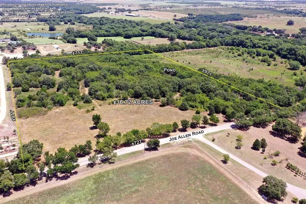 an aerial view of a house with a yard and lake view