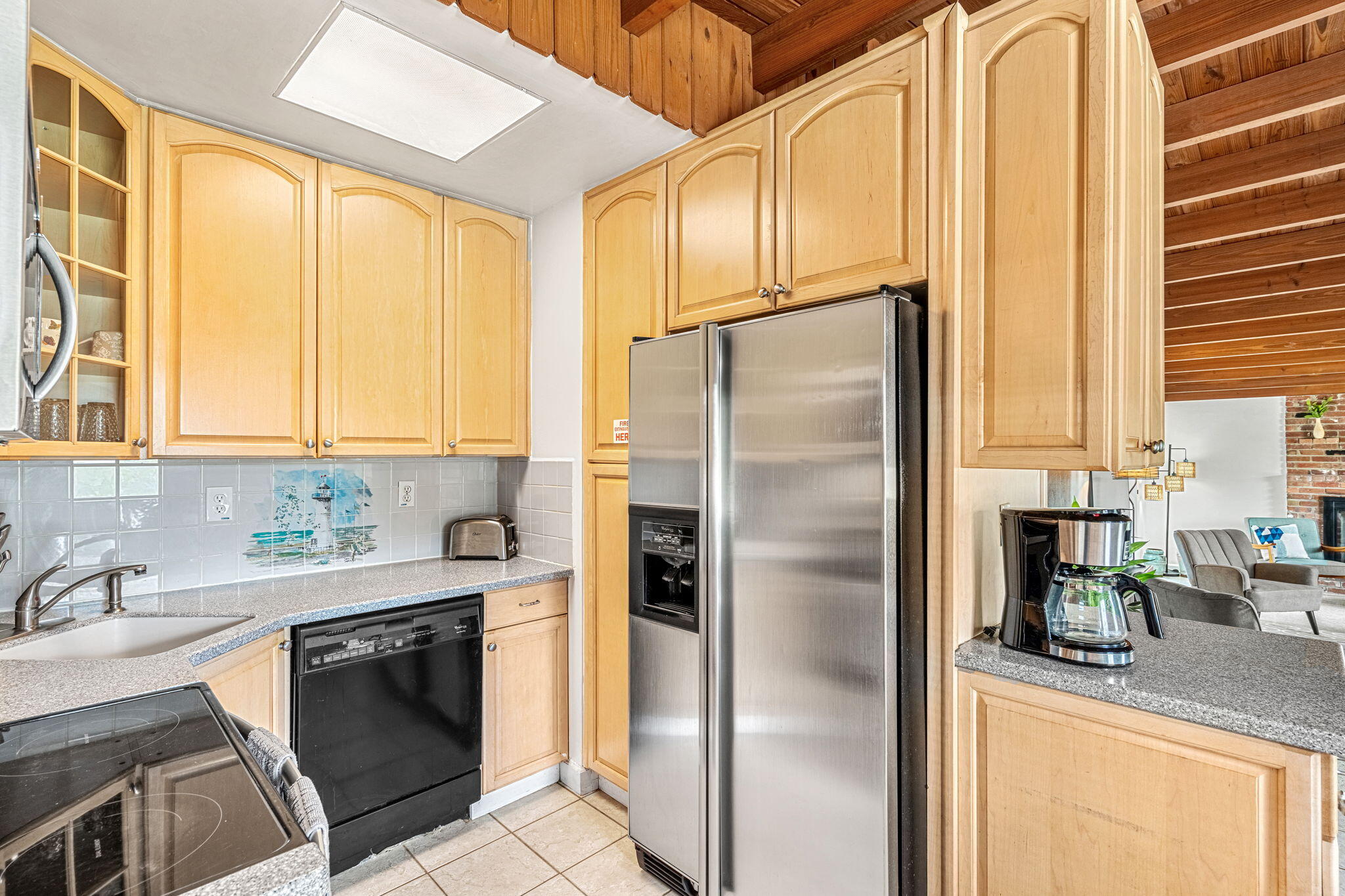 994 Samar Road Cocoa Beach, FL 32931 - Photo 10 of 34 a kitchen with stainless steel appliances granite countertop a refrigerator a sink and white cabinets