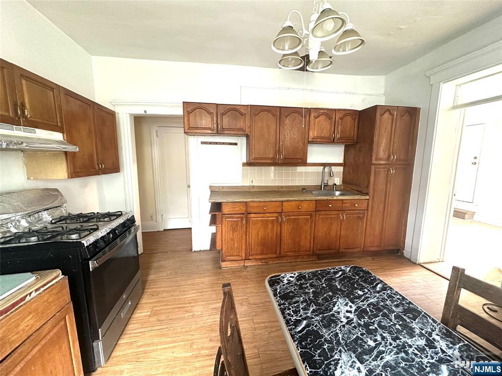 218 Main Street Ridgefield Park, NJ 07660 - Photo 2 of 8 a kitchen with a stove and a refrigerator