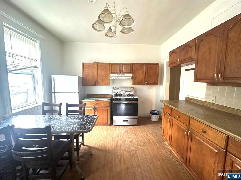 218 Main Street Ridgefield Park, NJ 07660 - Photo 3 of 8 a kitchen with granite countertop a stove a sink and a refrigerator
