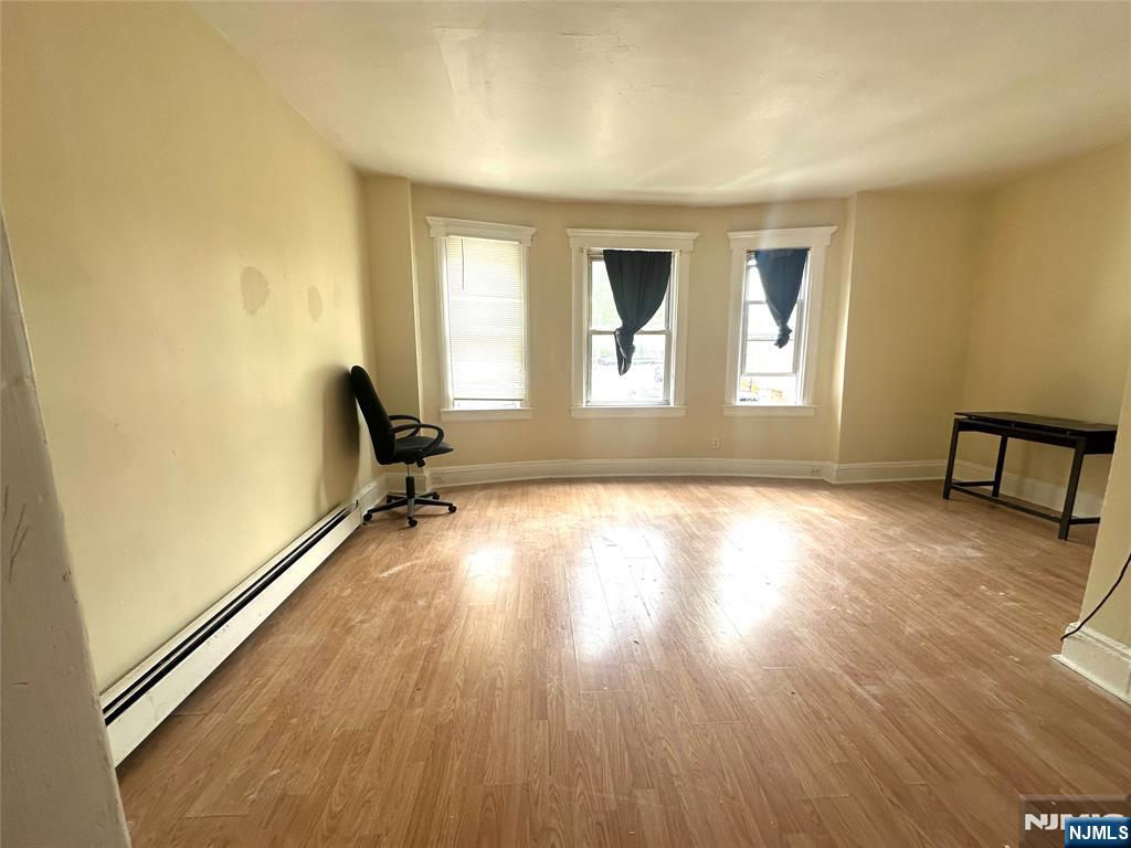 218 Main Street Ridgefield Park, NJ 07660 - Photo 5 of 8 a view of a room with wooden floor and window