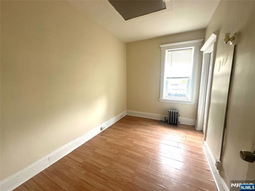 218 Main Street Ridgefield Park, NJ 07660 - Photo 8 of 8 an empty room with wooden floor and windows