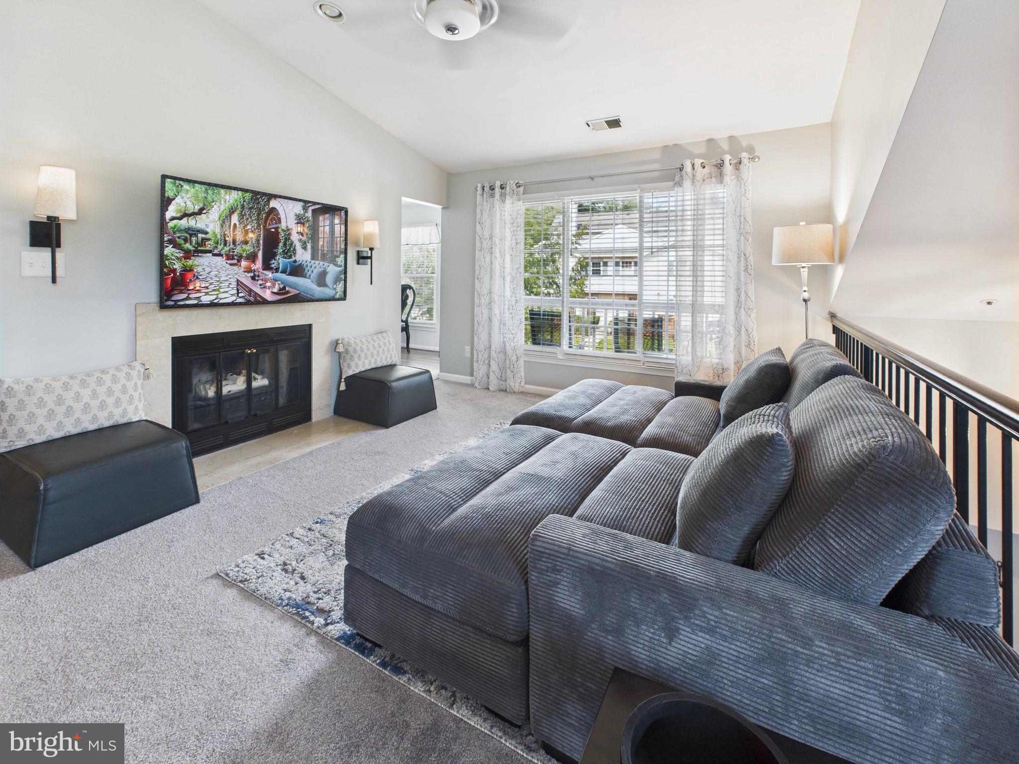 11269 Raging Brook Drive, Unit 258 Bowie, MD 20720 - Photo 11 of 36 a bedroom with a bed and a fireplace