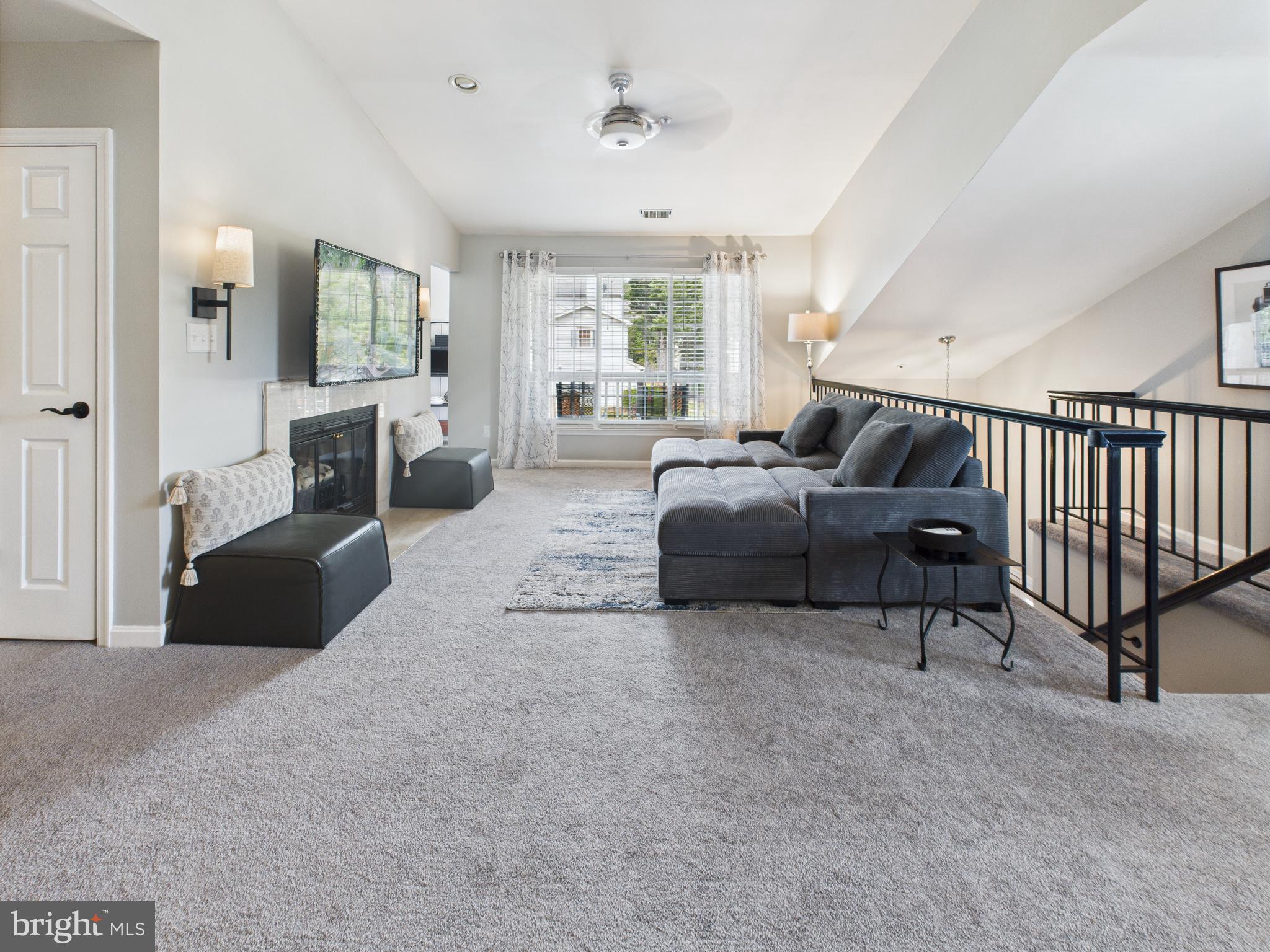 11269 Raging Brook Drive, Unit 258 Bowie, MD 20720 - Photo 12 of 36 a living room with furniture ceiling fan and a window