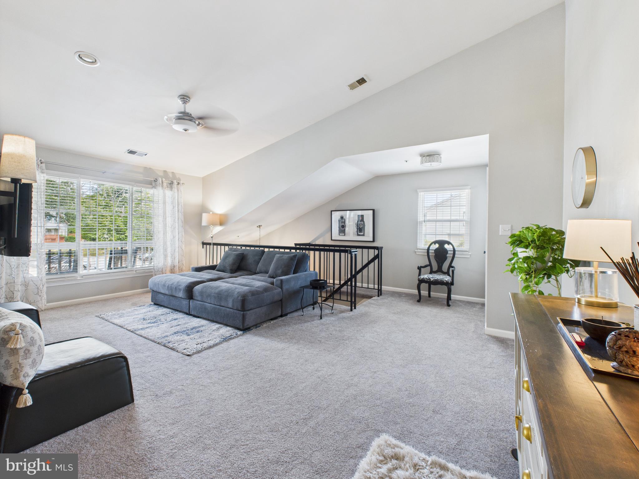 11269 Raging Brook Drive, Unit 258 Bowie, MD 20720 - Photo 13 of 36 a living room with furniture and a large window