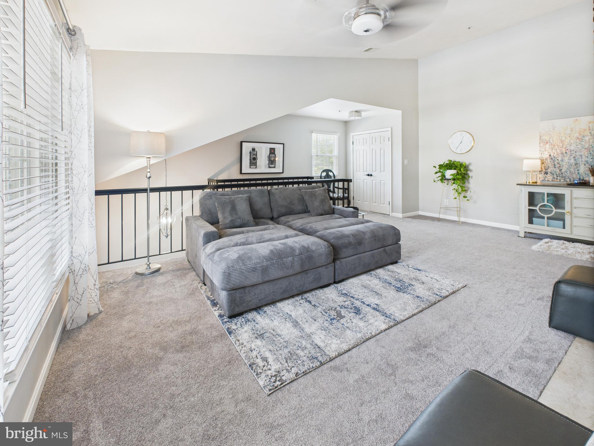 11269 Raging Brook Drive, Unit 258 Bowie, MD 20720 - Photo 14 of 36 a living room with furniture and a chandelier