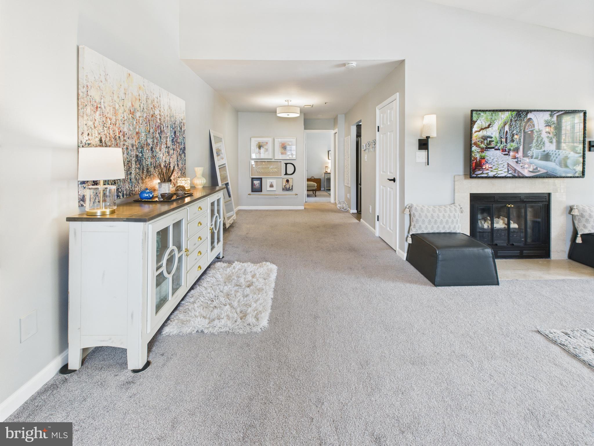11269 Raging Brook Drive, Unit 258 Bowie, MD 20720 - Photo 15 of 36 a view of a kitchen cabinets and a livingroom