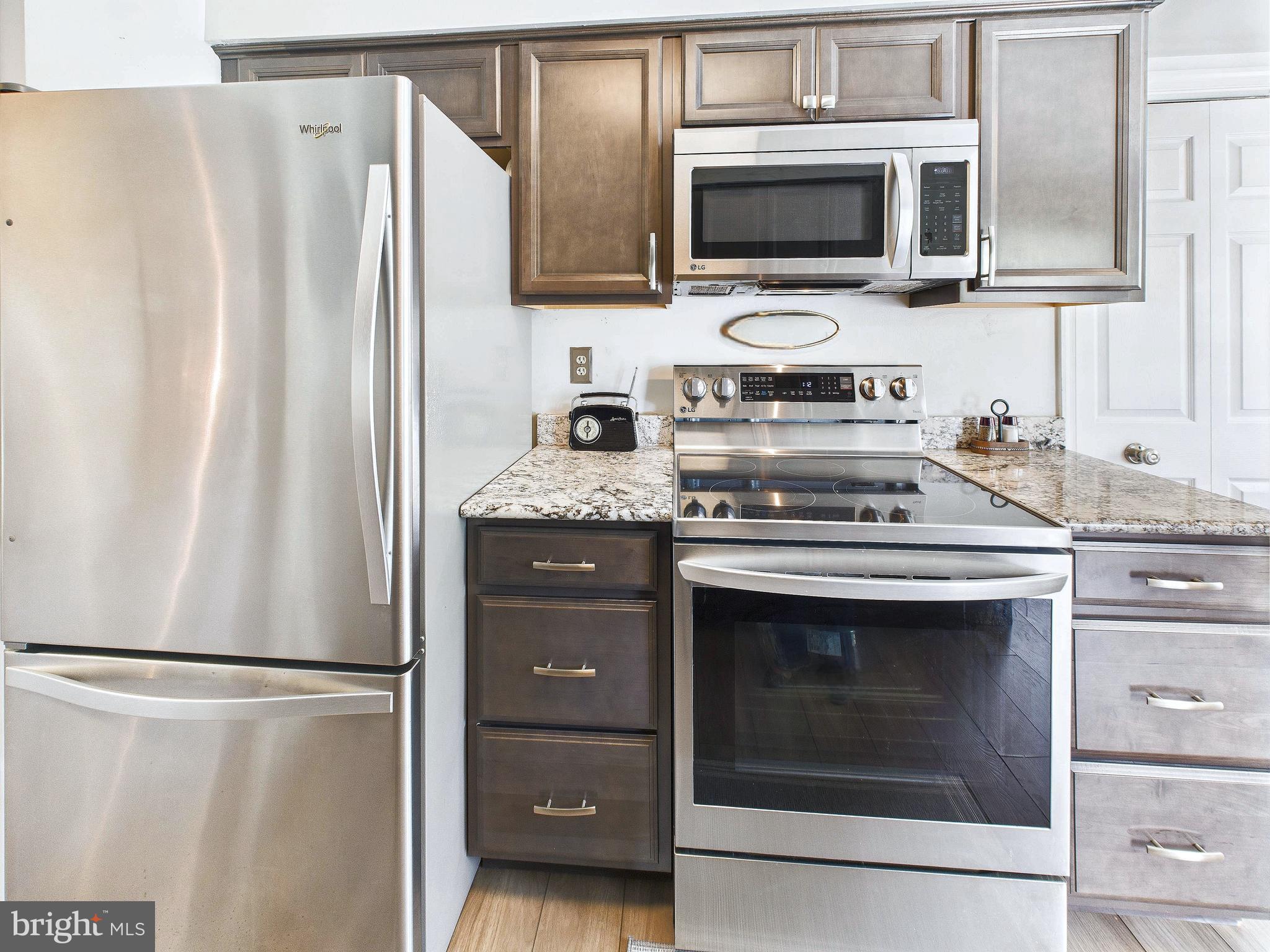 11269 Raging Brook Drive, Unit 258 Bowie, MD 20720 - Photo 20 of 36 a kitchen with stainless steel appliances a refrigerator stove and microwave