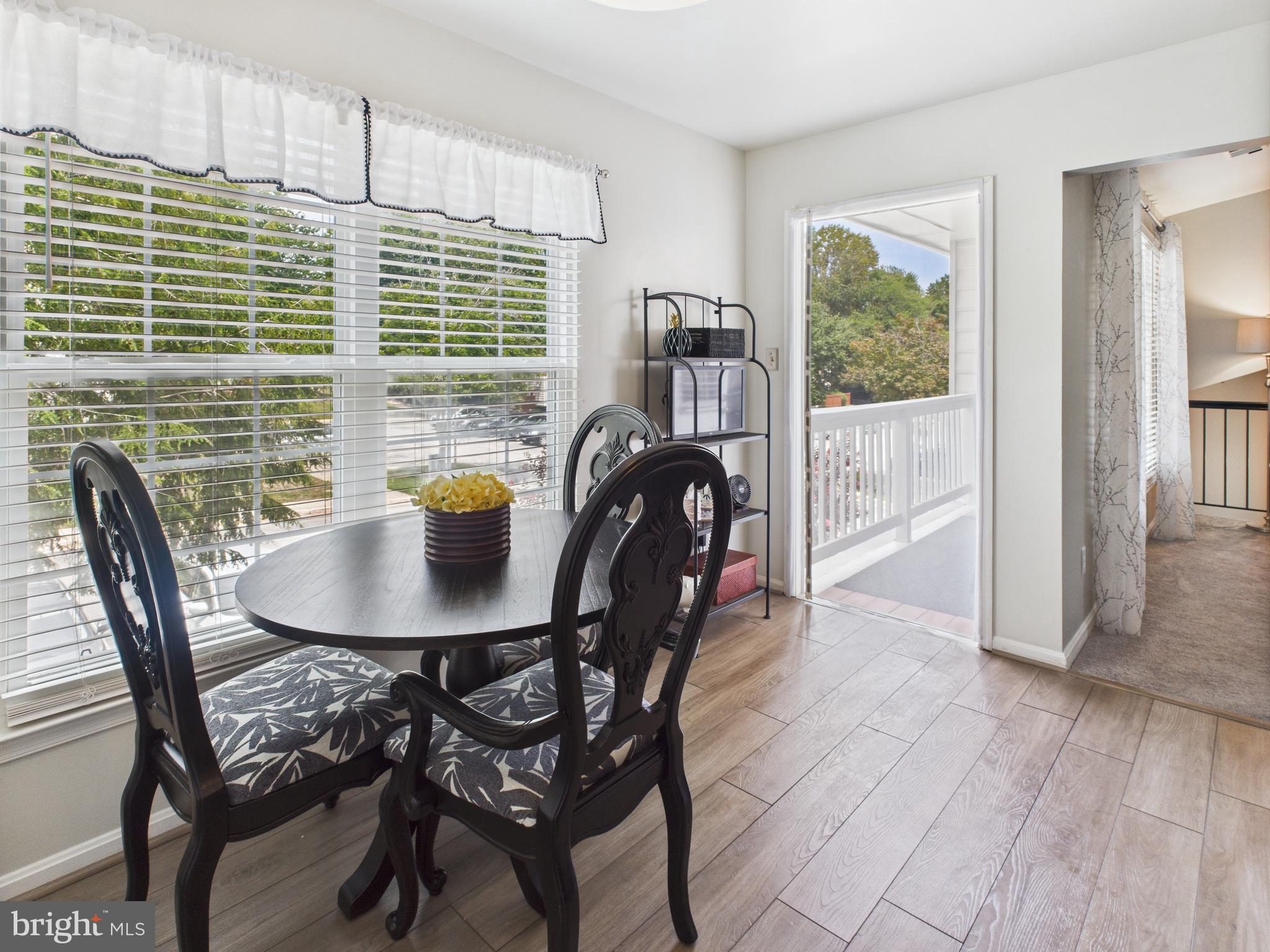 11269 Raging Brook Drive, Unit 258 Bowie, MD 20720 - Photo 22 of 36 a dining room with furniture and wooden floor