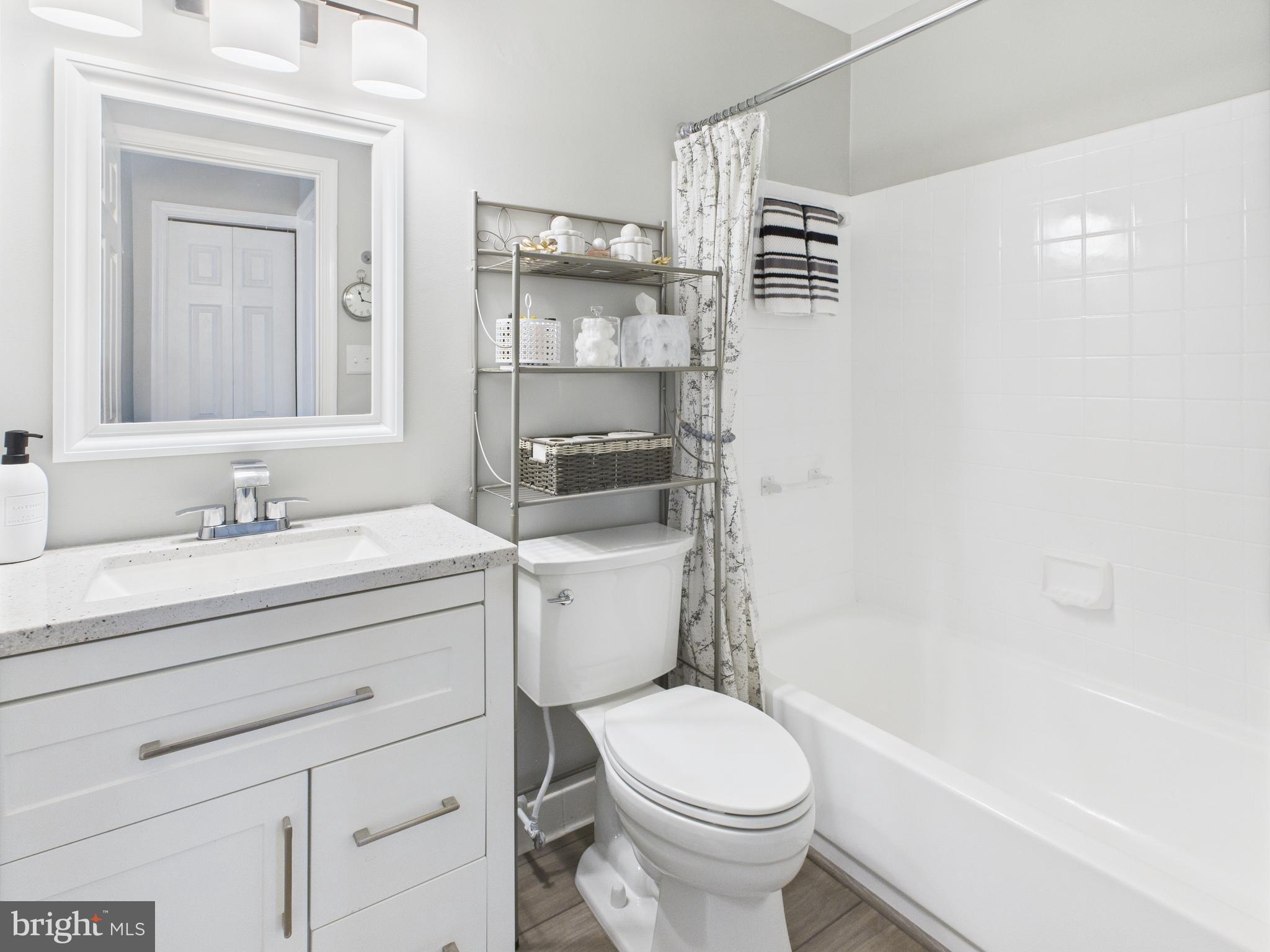 11269 Raging Brook Drive, Unit 258 Bowie, MD 20720 - Photo 24 of 36 a bathroom with a sink a toilet and shower