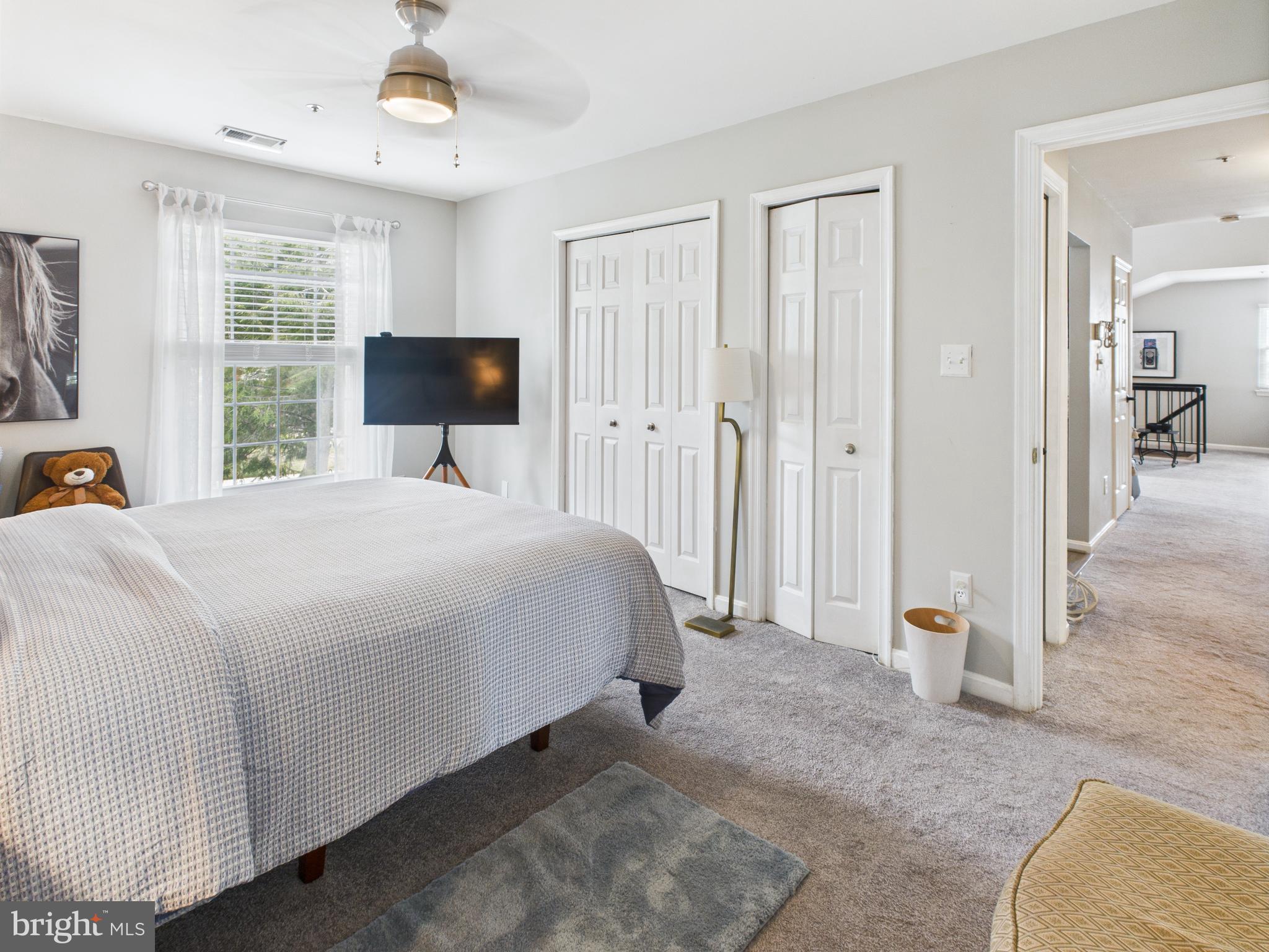 11269 Raging Brook Drive, Unit 258 Bowie, MD 20720 - Photo 27 of 36 a bedroom with a bed and a chandelier