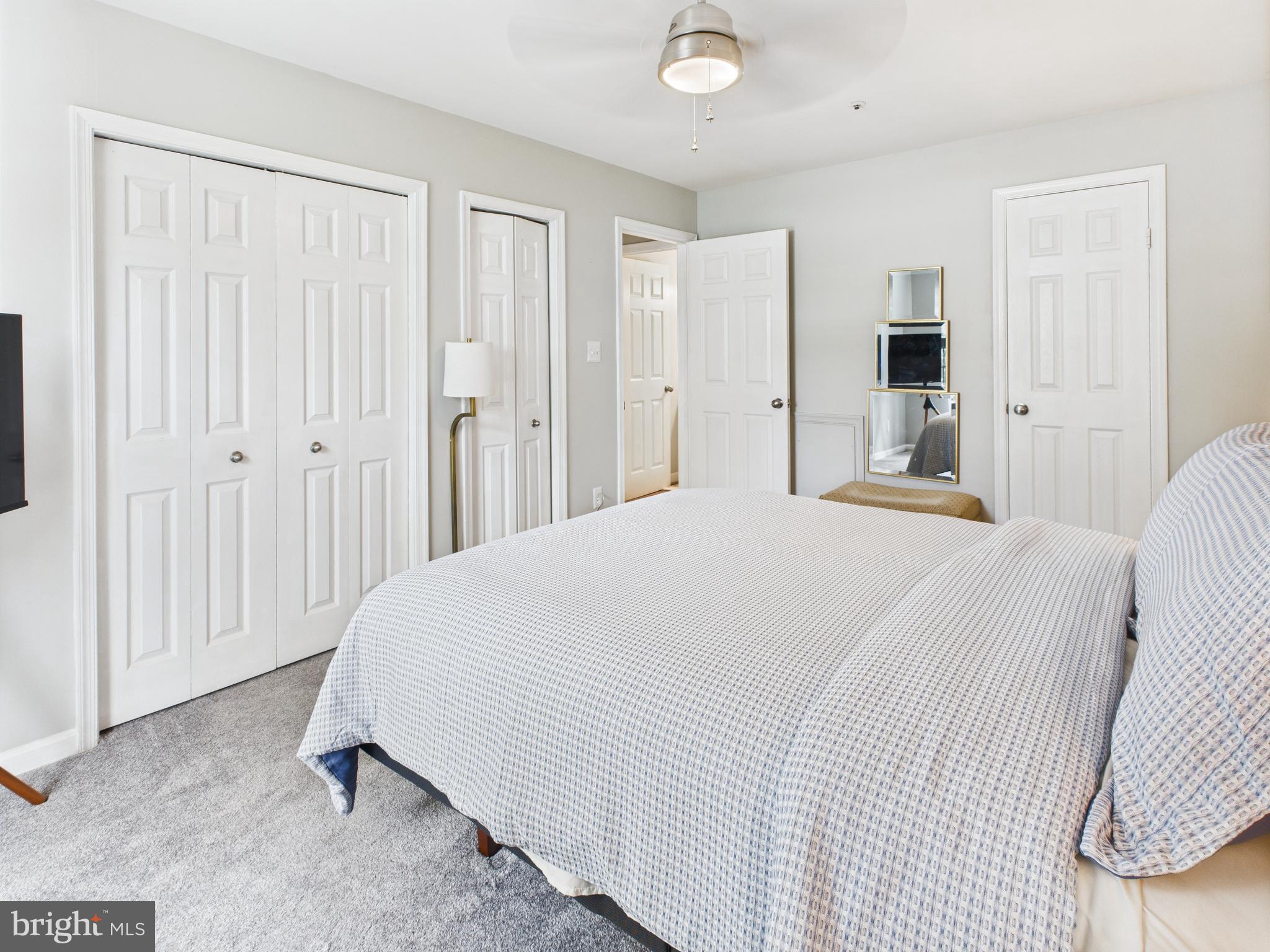 11269 Raging Brook Drive, Unit 258 Bowie, MD 20720 - Photo 29 of 36 a bedroom with a bed and a walk in closet