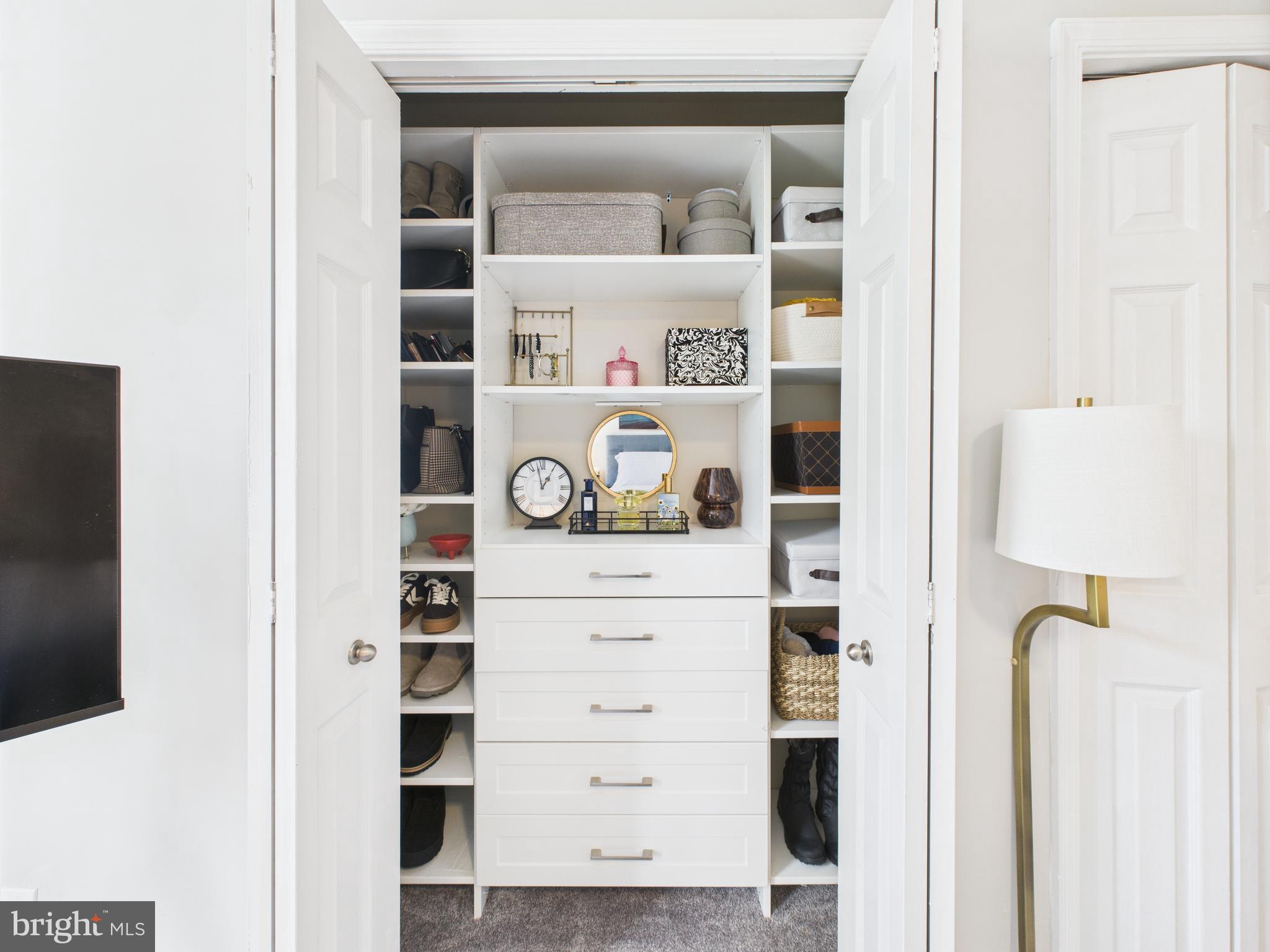 11269 Raging Brook Drive, Unit 258 Bowie, MD 20720 - Photo 30 of 36 a view of walk in closet with clothes and shoes