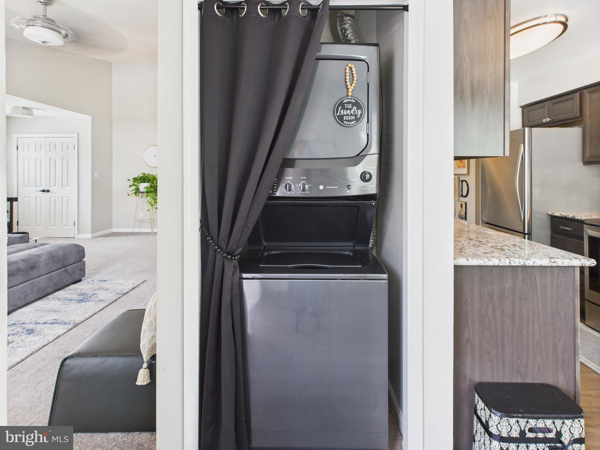 11269 Raging Brook Drive, Unit 258 Bowie, MD 20720 - Photo 31 of 36 a kitchen with a refrigerator and a stove