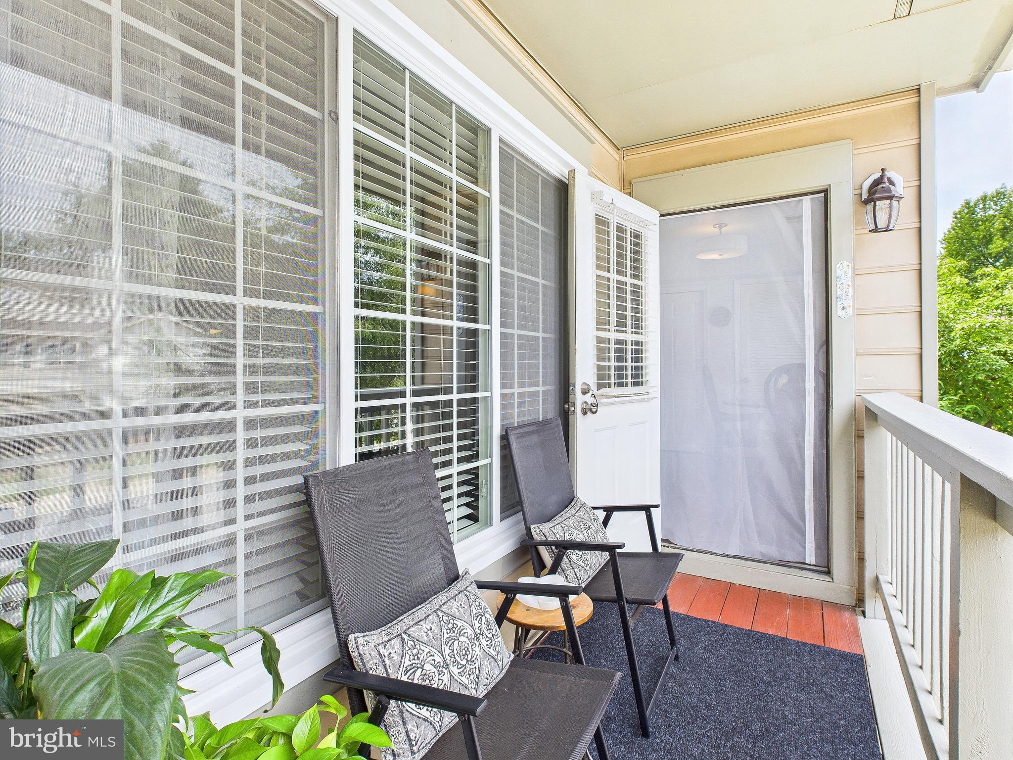11269 Raging Brook Drive, Unit 258 Bowie, MD 20720 - Photo 33 of 36 a view of a chair and table in the balcony