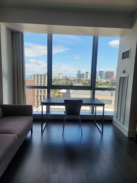 110 Stuart Street, Unit 19D Boston, MA 02116 - Photo 11 of 18 a view of a livingroom with furniture and floor to ceiling window