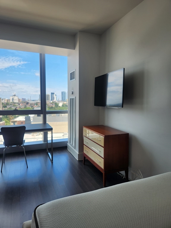110 Stuart Street, Unit 19D Boston, MA 02116 - Photo 12 of 18 a living room with furniture and floor to ceiling window