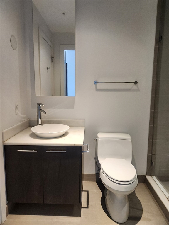 110 Stuart Street, Unit 19D Boston, MA 02116 - Photo 16 of 18 a bathroom with a toilet sink and mirror