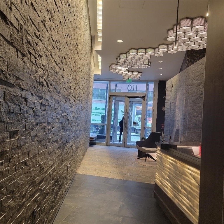 110 Stuart Street, Unit 19D Boston, MA 02116 - Photo 4 of 18 a view of a lobby with chair and chandelier