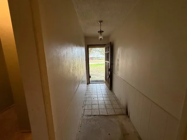 a room with pool table and windows