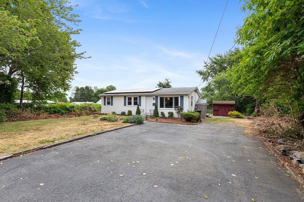 99 Swansom Road Swansea, MA 02777 - Photo 2 of 42 a front view of a house with a yard and trees