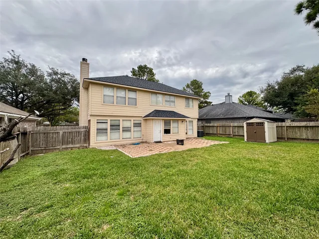 a view of a house with a yard and sitting area