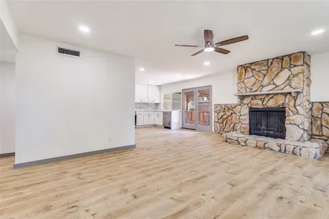 an empty room with furniture and a fireplace