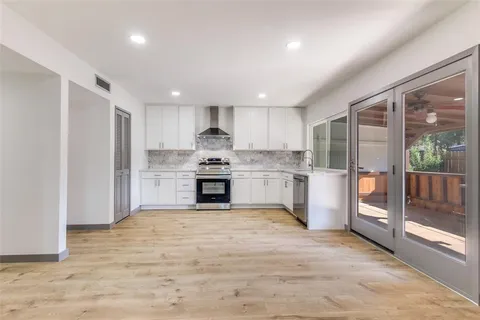 a kitchen with stainless steel appliances granite countertop a refrigerator sink and cabinets