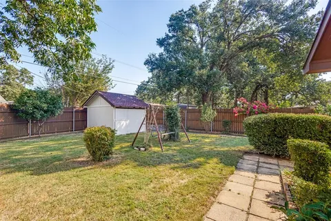 a backyard of a house with table and chairs
