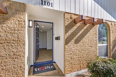 a view of a door and wooden floor