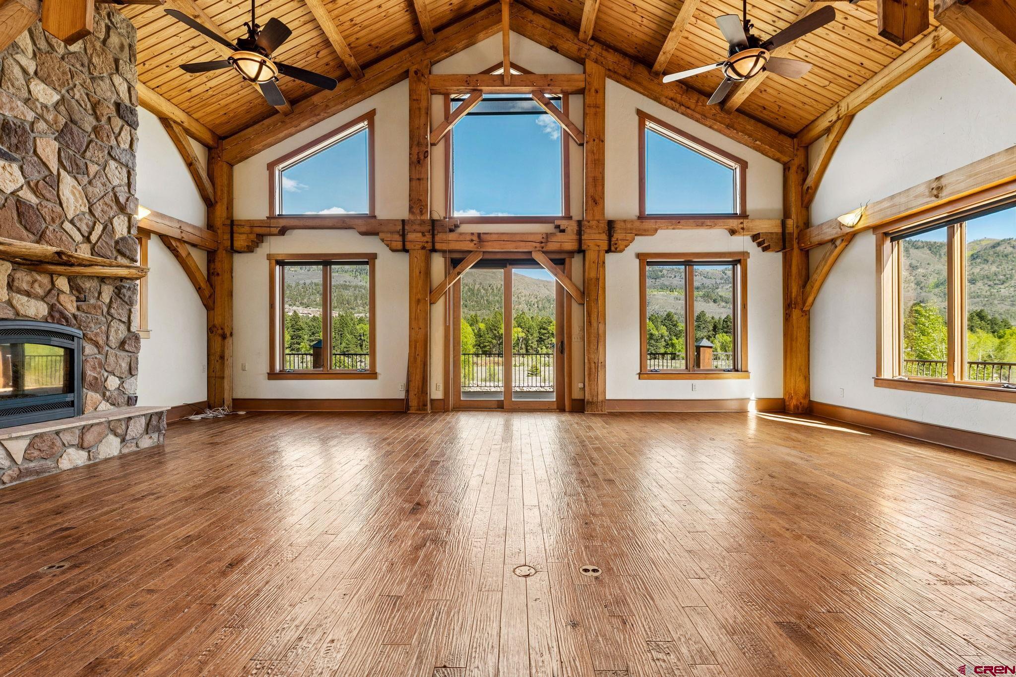 300 Animas Springs Road Durango, CO 81301 - Photo 13 of 44 an empty room with wooden floor and windows
