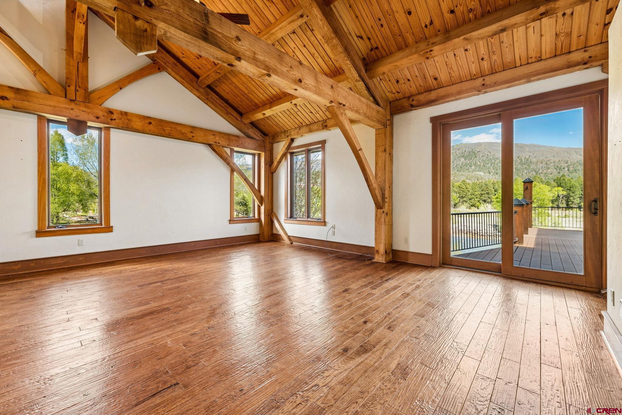 300 Animas Springs Road Durango, CO 81301 - Photo 20 of 44 a view of an empty room with wooden floor and a window