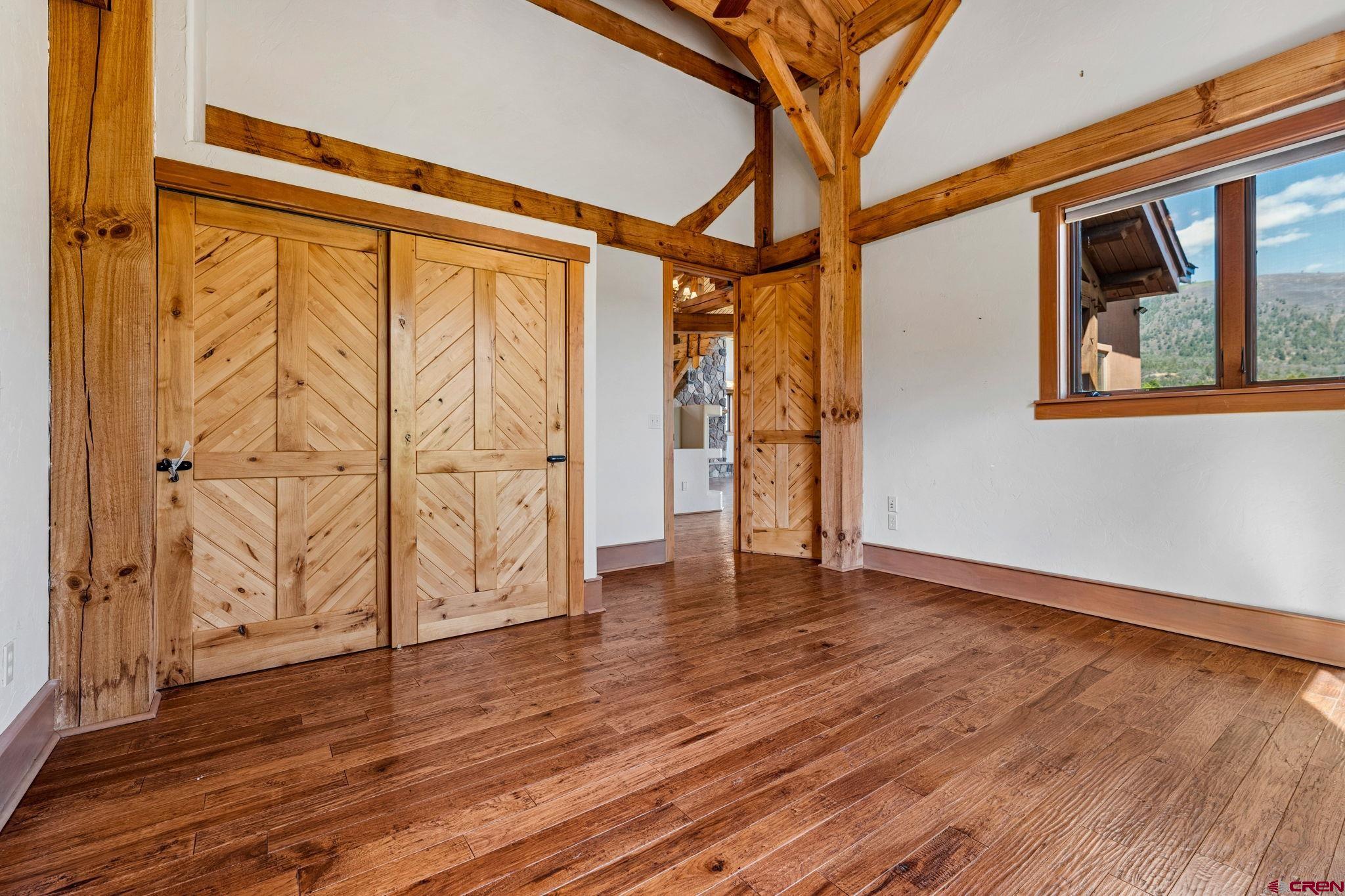 300 Animas Springs Road Durango, CO 81301 - Photo 28 of 44 a view of an empty room with wooden floor and a window