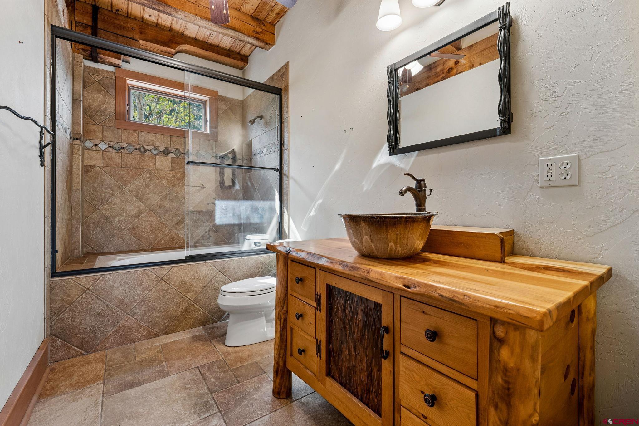 300 Animas Springs Road Durango, CO 81301 - Photo 29 of 44 a bathroom with a granite countertop sink a toilet and a shower