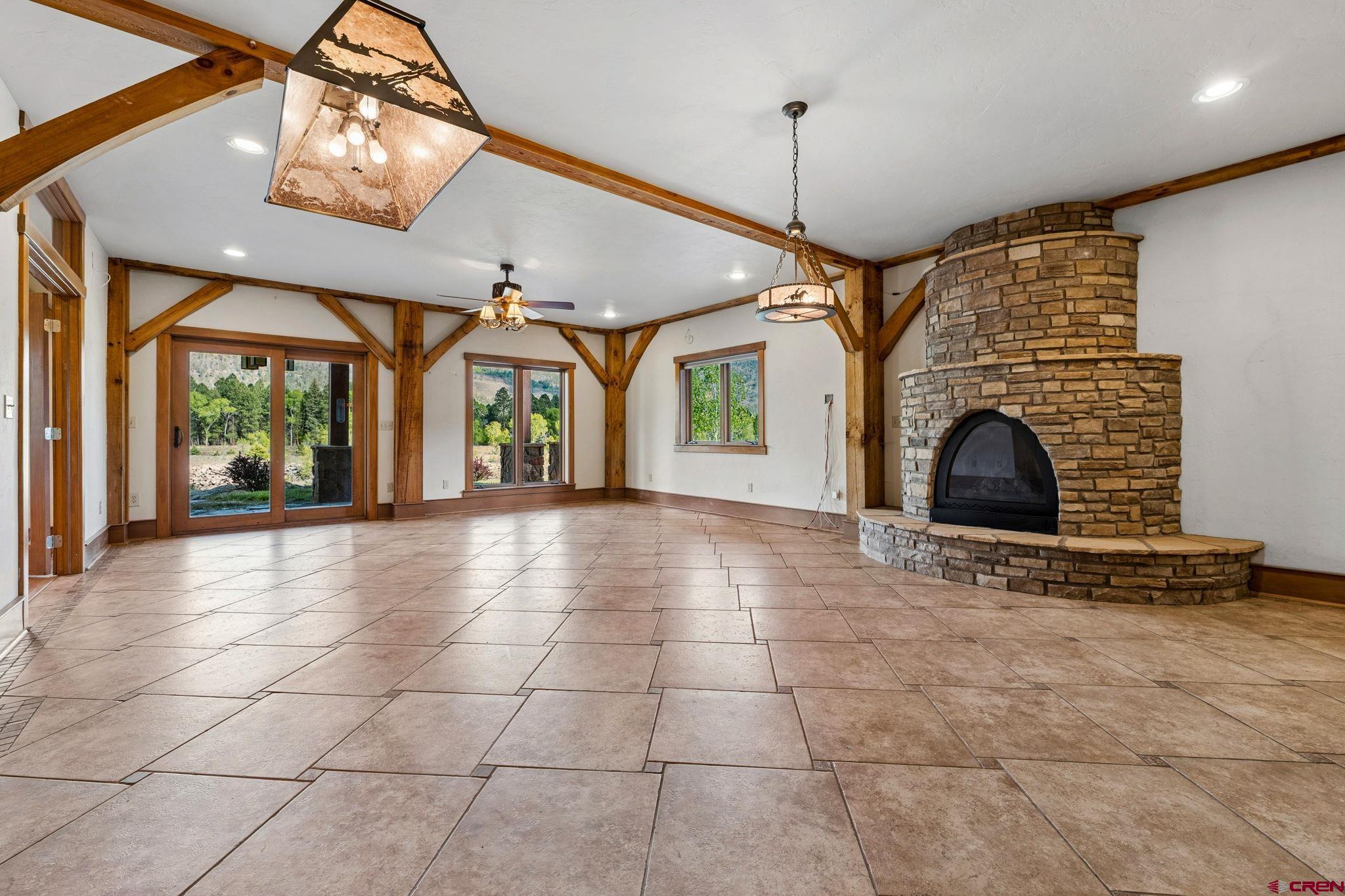 300 Animas Springs Road Durango, CO 81301 - Photo 33 of 44 a view of an empty room with a fireplace and windows