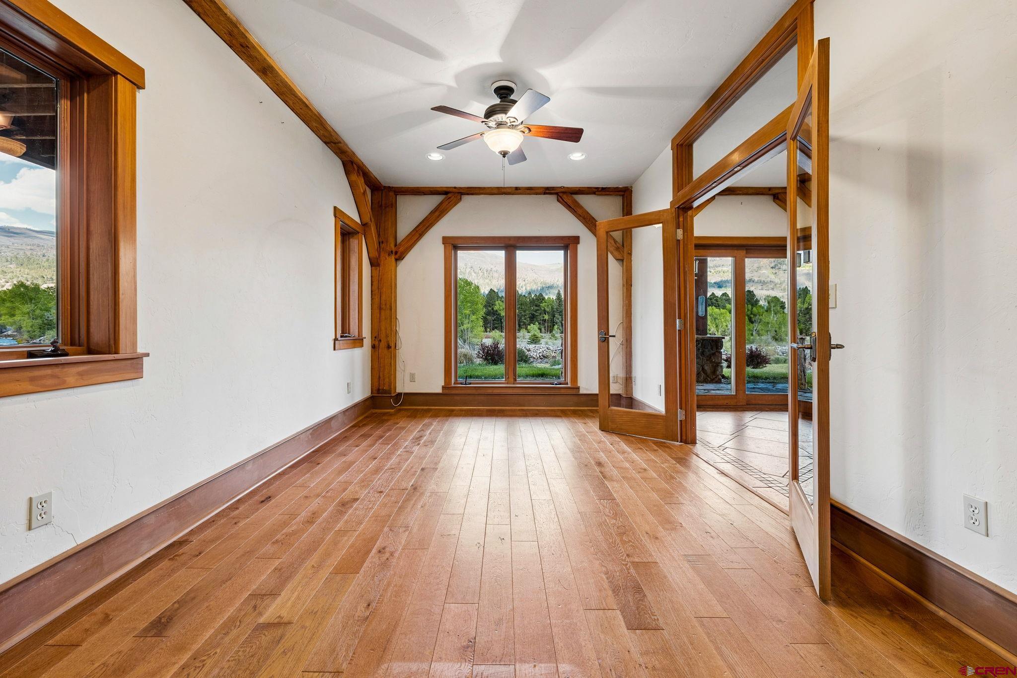 300 Animas Springs Road Durango, CO 81301 - Photo 37 of 44 a view of an empty room with wooden floor and a window