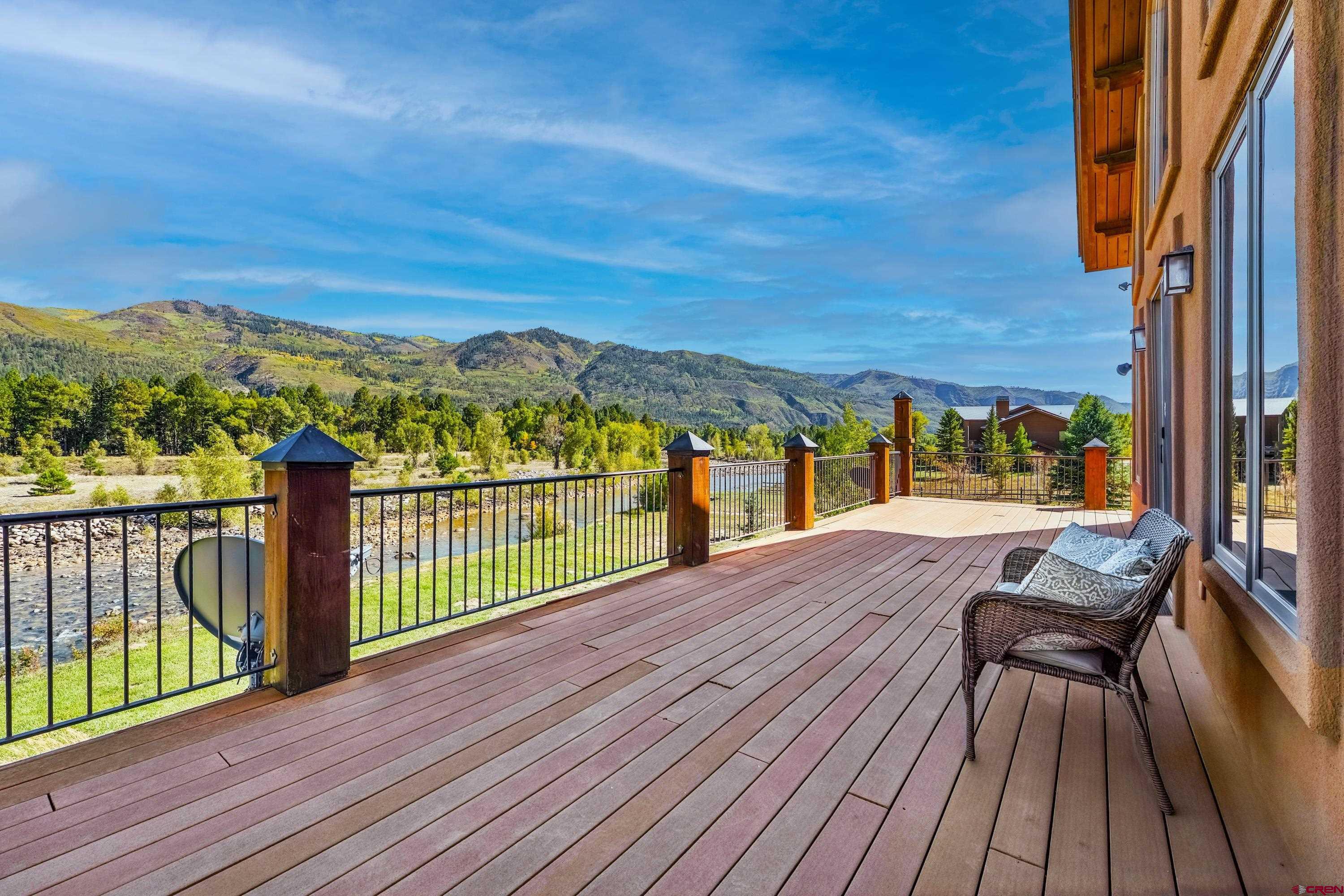 300 Animas Springs Road Durango, CO 81301 - Photo 39 of 44 a view of a balcony with wooden floor next to a yard