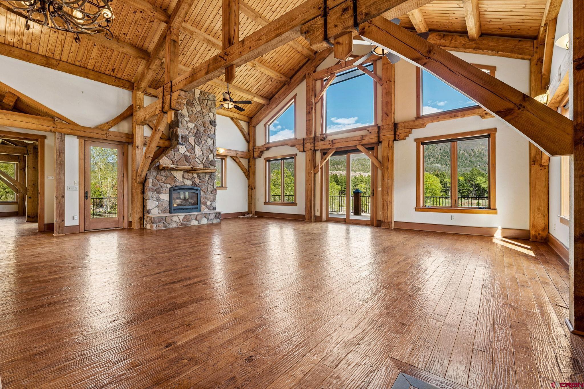 300 Animas Springs Road Durango, CO 81301 - Photo 7 of 44 an empty room with wooden floor and windows