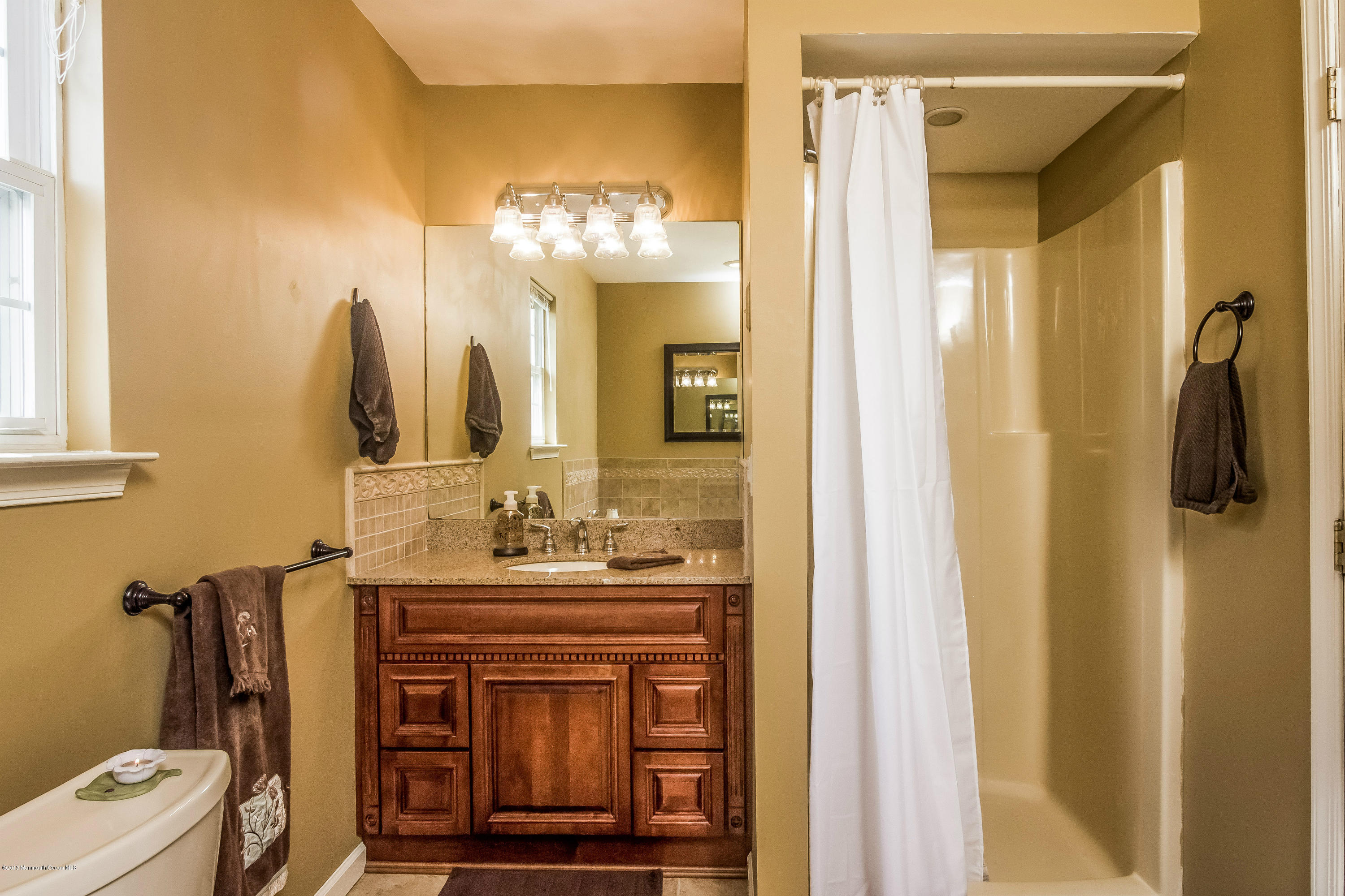 17 Rizzo Court Howell, NJ 07731 - Photo 10 of 15 a bathroom with a sink vanity and a mirror