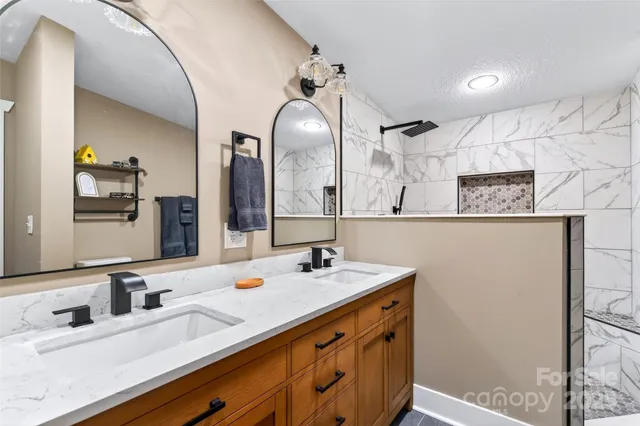 a bathroom with a double vanity sink and a mirror