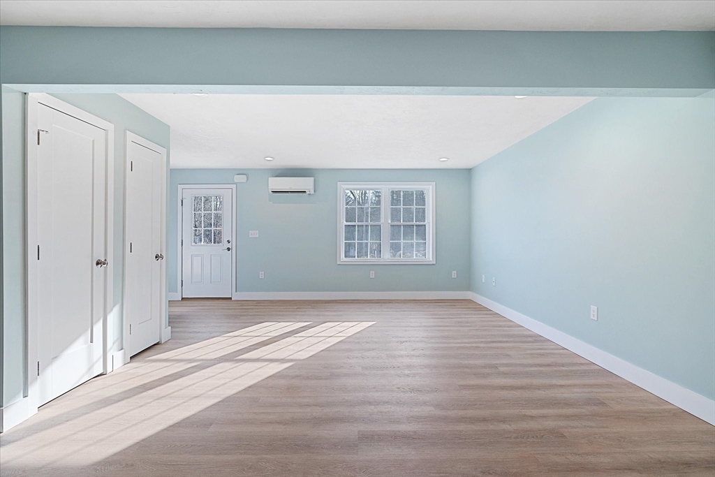 60 Hill Road, Unit B Charlton, MA 01507 - Photo 3 of 11 a view of an empty room with wooden floor and a window