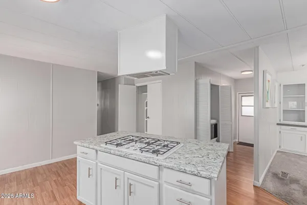 a kitchen with kitchen island a sink appliances and cabinets