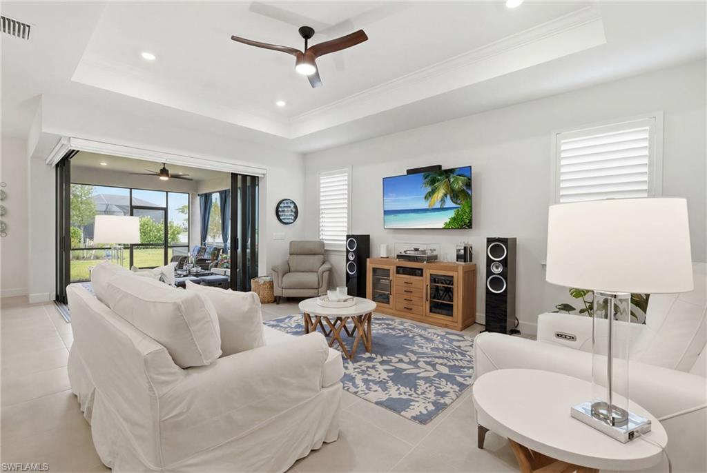 18364 Ridgeline Drive Estero, FL 33928 - Photo 11 of 50 a living room with furniture a fireplace and a flat screen tv