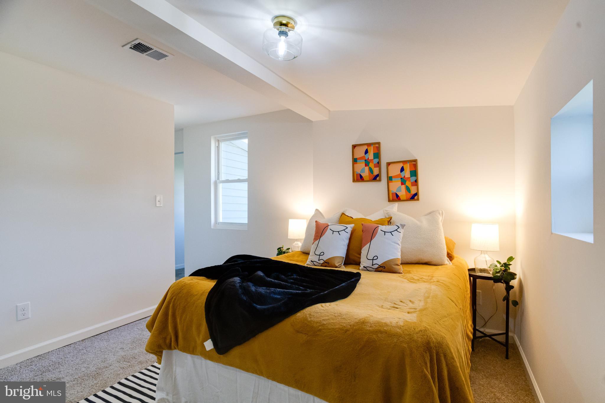 4417 Walnut Road Halethorpe, MD 21227 - Photo 20 of 44 a bedroom with a bed and wooden floor