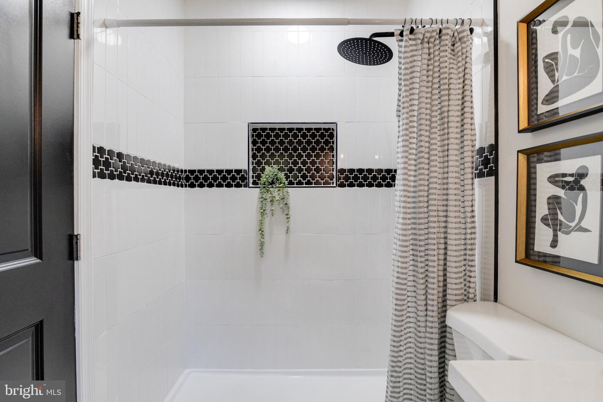 4417 Walnut Road Halethorpe, MD 21227 - Photo 25 of 44 a bathroom with a shower curtain and a toilet