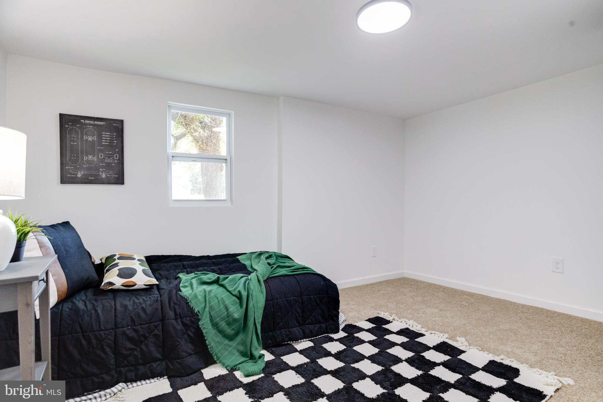 4417 Walnut Road Halethorpe, MD 21227 - Photo 26 of 44 a bedroom with a bed and a chair