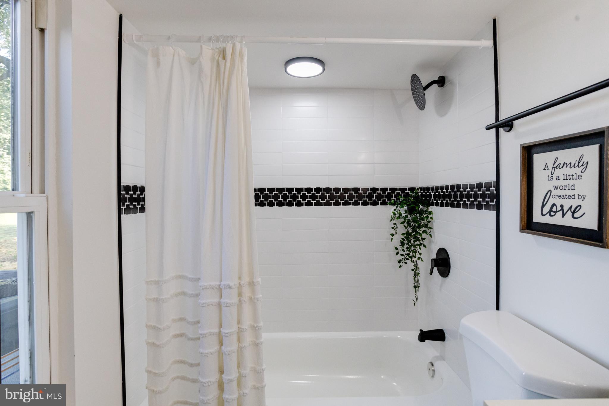 4417 Walnut Road Halethorpe, MD 21227 - Photo 31 of 44 a bathroom with a bathtub and a shower