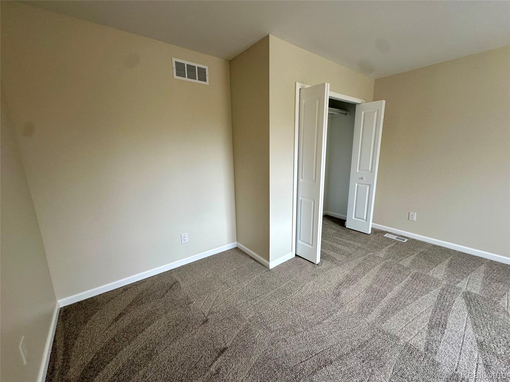 2670 Riley Center Road Memphis, MI 48041 - Photo 27 of 39 Unfurnished bedroom featuring carpet floors and a closet