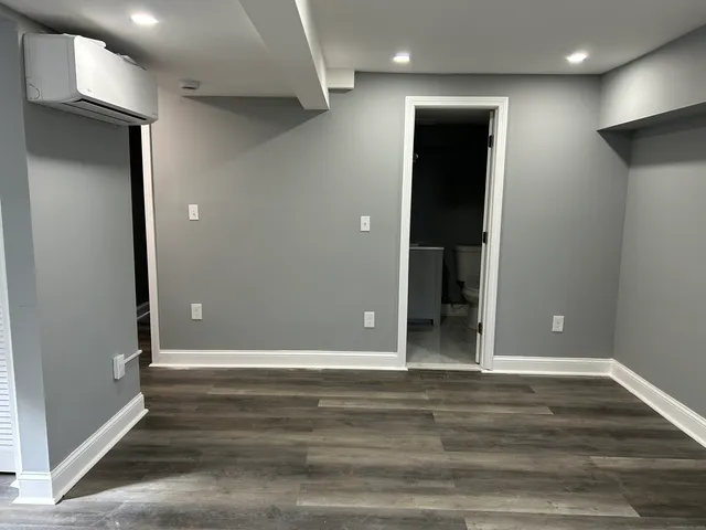 an empty room with wooden floor and closet