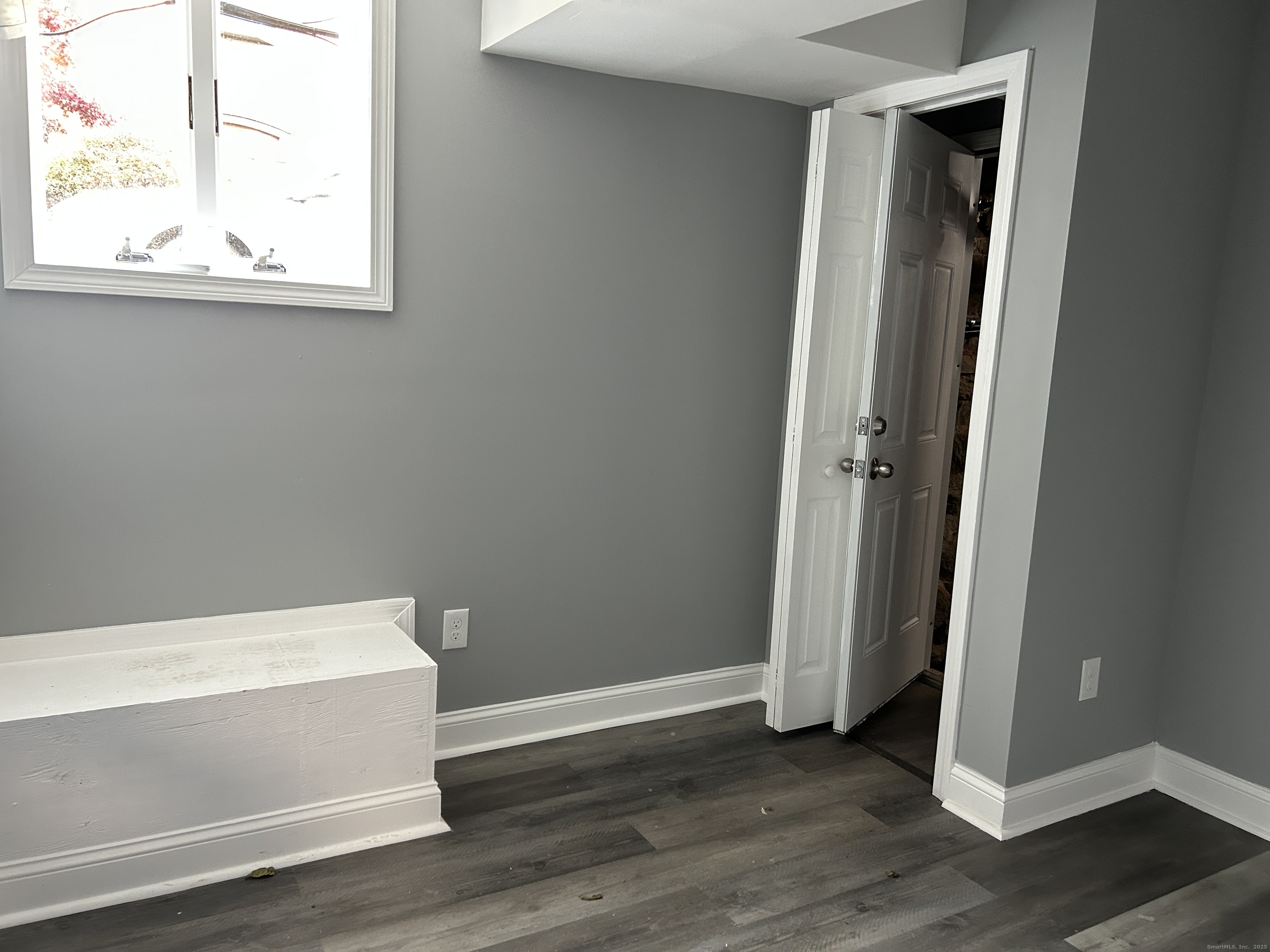 22 Hawthorne Street, Unit 1 Norwich, CT 06360 - Photo 13 of 22 a view of an empty room with wooden floor and a window